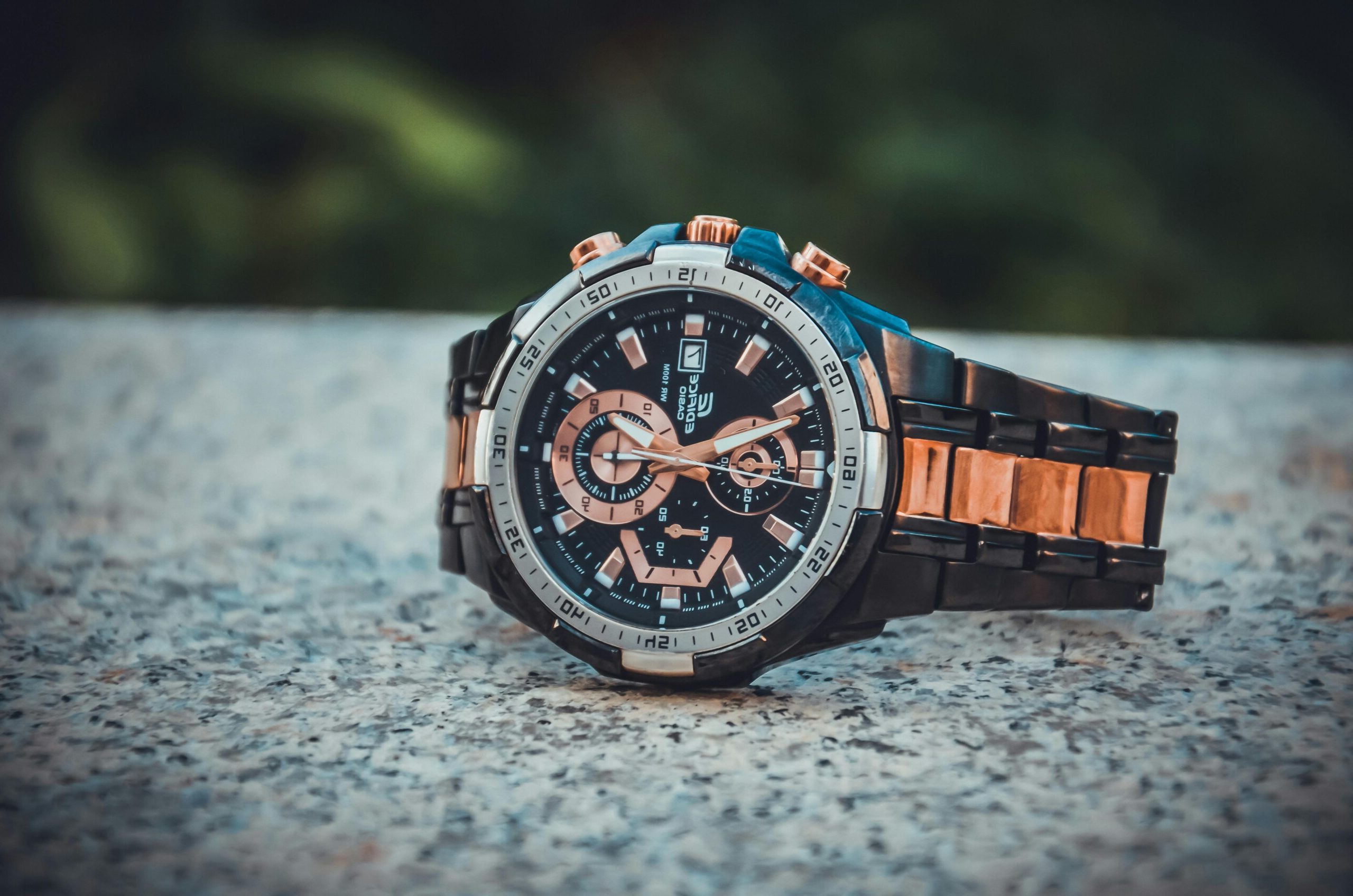 Close-up of an elegant wristwatch with a metal band, highlighting its intricate design and timekeeping features.